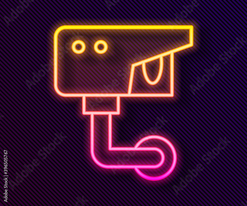 Glowing neon line Security camera icon isolated on black background. Vector.