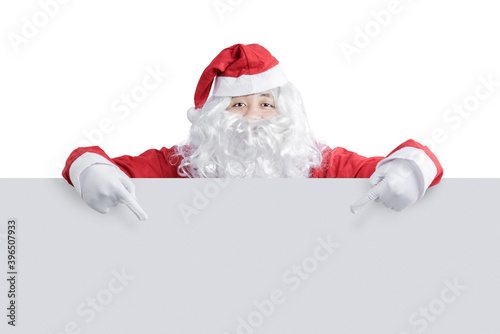 Asian man in Santa costume showing empty board
