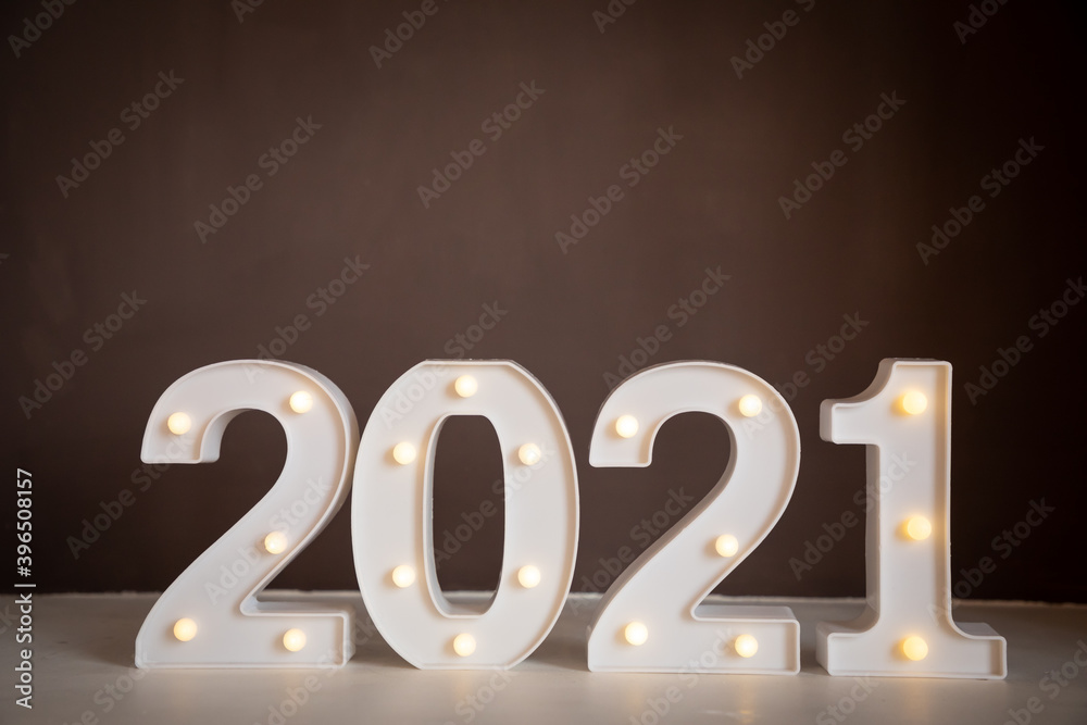 Figures 2021 with lights on brown background. Merry Christmas and Happy New Year 2021 Figures 2021 with lights on brown background. Merry Christmas and Happy New Year 2021