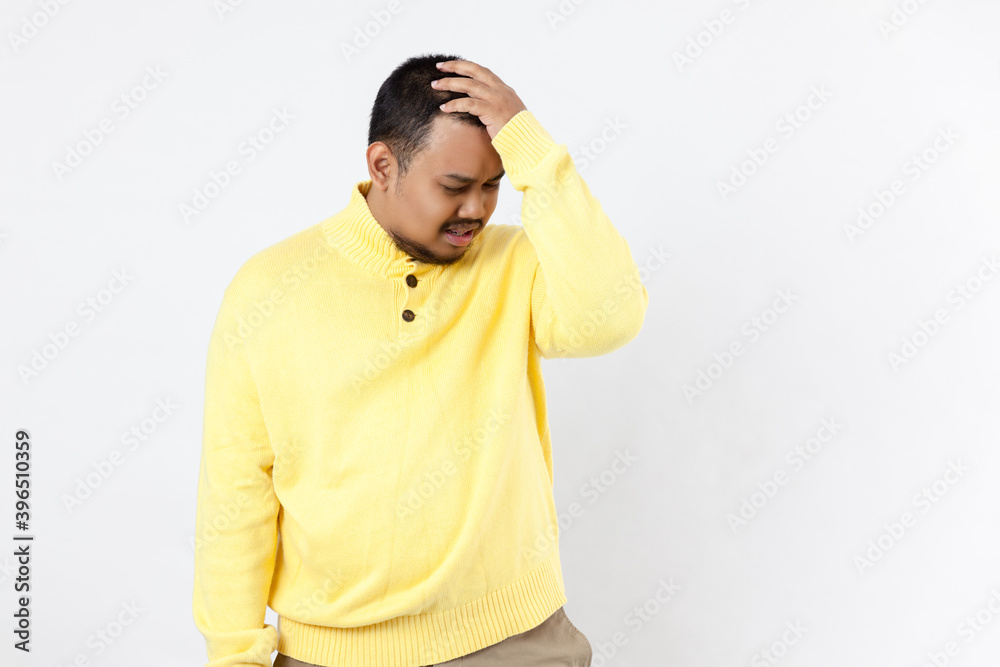 Upset unhappy asia man in yellow shirt squeezing head with hands, suffering from headache. People, stress, tension and migraine concept
Upset unhappy asia man in yellow shirt squeezing head with hands, suffering from headache. People, stress, tension and migraine concept