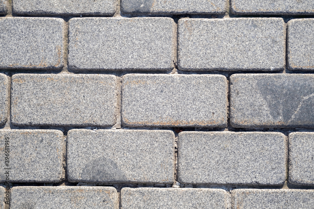 Background of gray granite tiles in the form of brickwork Background of gray granite tiles in the form of brickwork