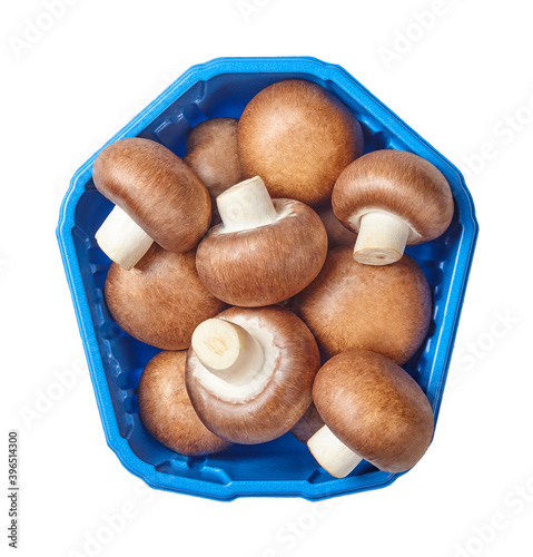 Champignon mushrooms in a plastic pack isolated on a white background. Directly above.