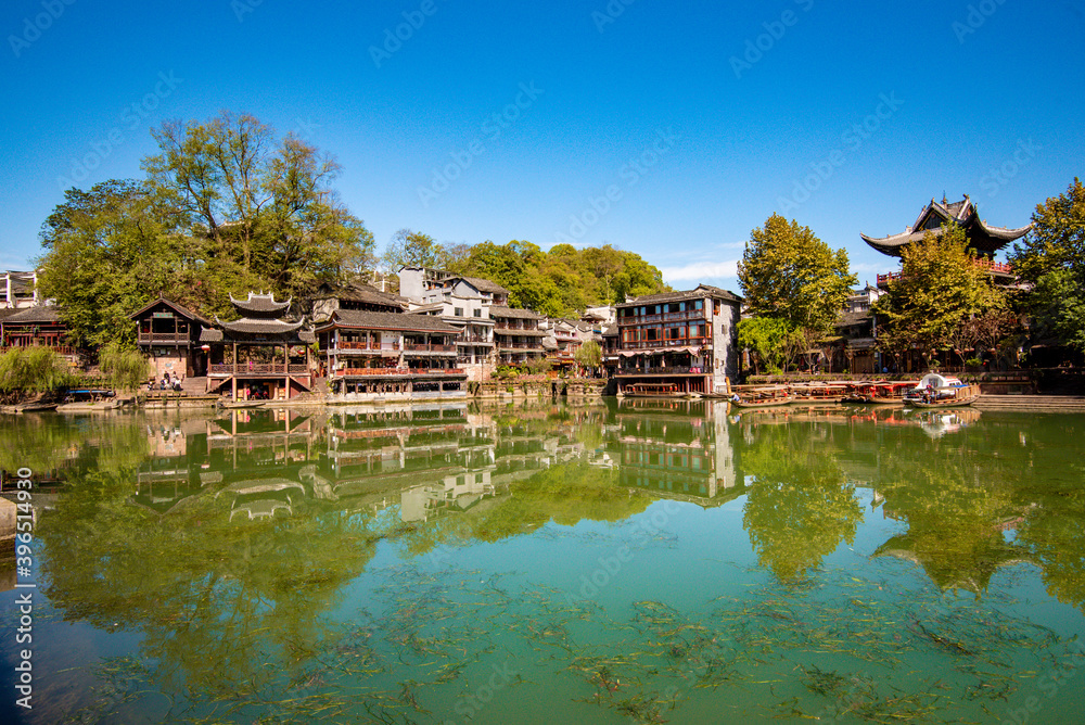 the river, the boat, stone bridge and the old houses at ancient phoenix town in the morning at Hunan, China. the river, the boat, stone bridge and the old houses at ancient phoenix town in the morning at Hunan, China.