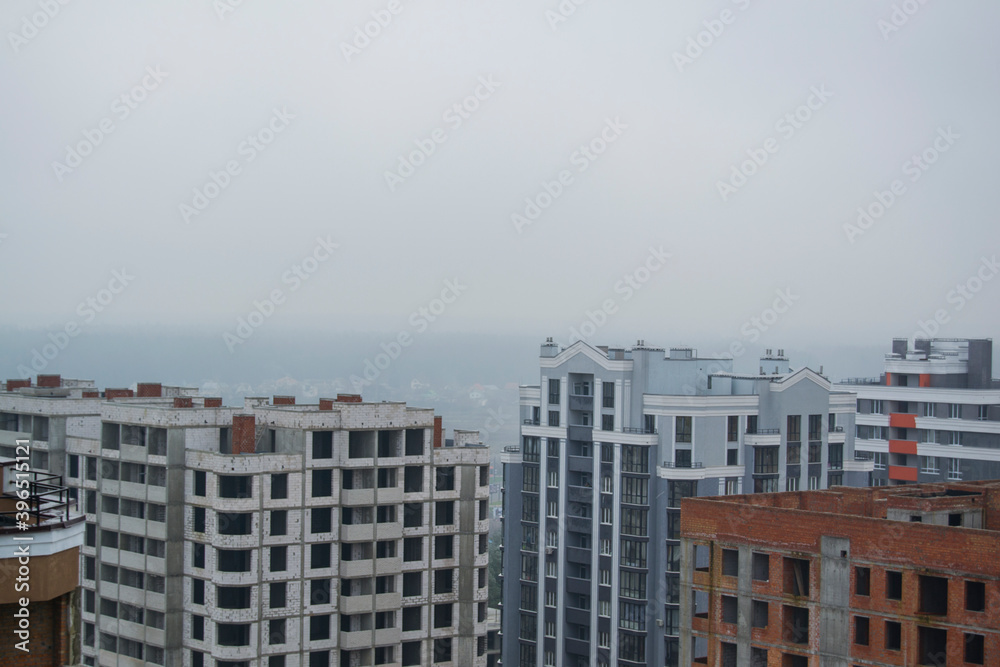 new houses with fog hanging over them new houses with fog hanging over them