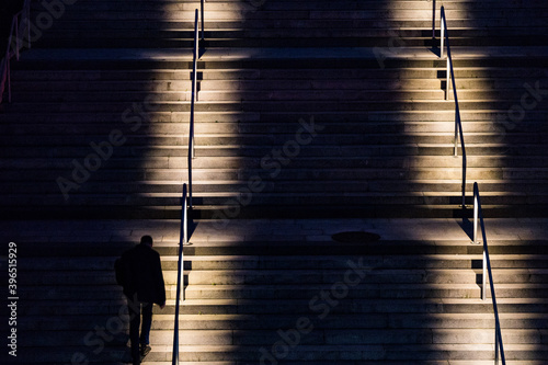 Photography Stockholm, Sweden A man runs up the stairs at night for exercise.