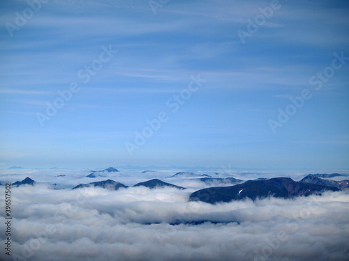 Kamchatka. Gorely Volcano (Burnt Volcano). Mountain peaks rising above the fog. Archive photo, 2008