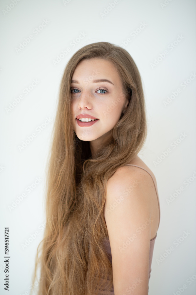 Portrait of a beautiful young smiling woman with clean skin, beauty treatment, cosmetology and anti-aging theme Portrait of a beautiful young smiling woman with clean skin, beauty treatment, cosmetology and anti-aging theme