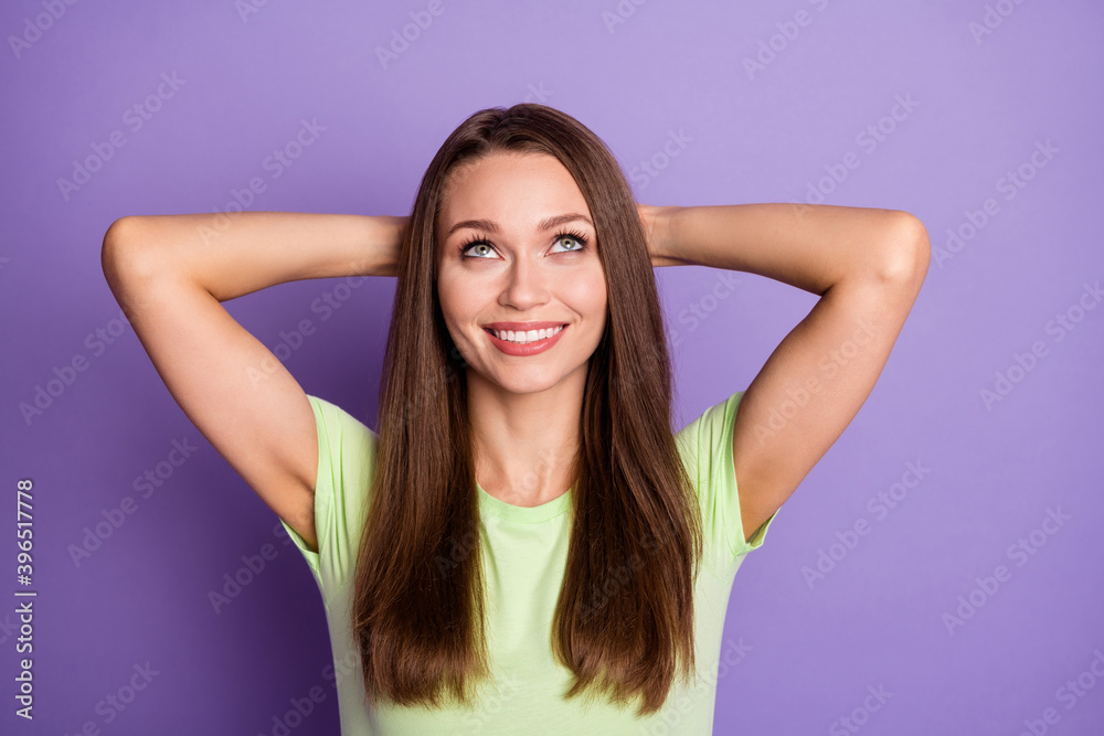 Photo portrait of relaxed girl with hands behind head looking up isolated on vivid purple colored background Photo portrait of relaxed girl with hands behind head looking up isolated on vivid purple colored background