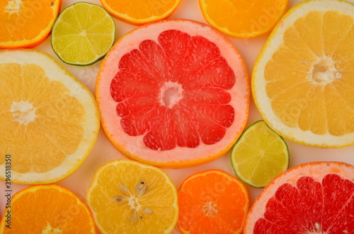 Sliced citrus fruits background. Red grapefruit  oranges  lemons  lime  mandarins