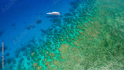 Drone flight over the beautiful Great Barrier Reef with an lonely small ship