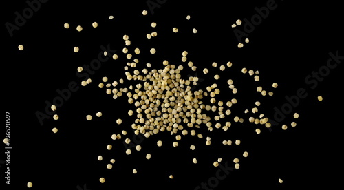 Peeled yellow millet seeds, organic food product isolated on black background, top view