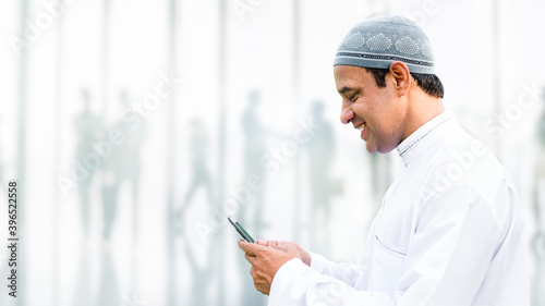Muslim man using a phone photo
