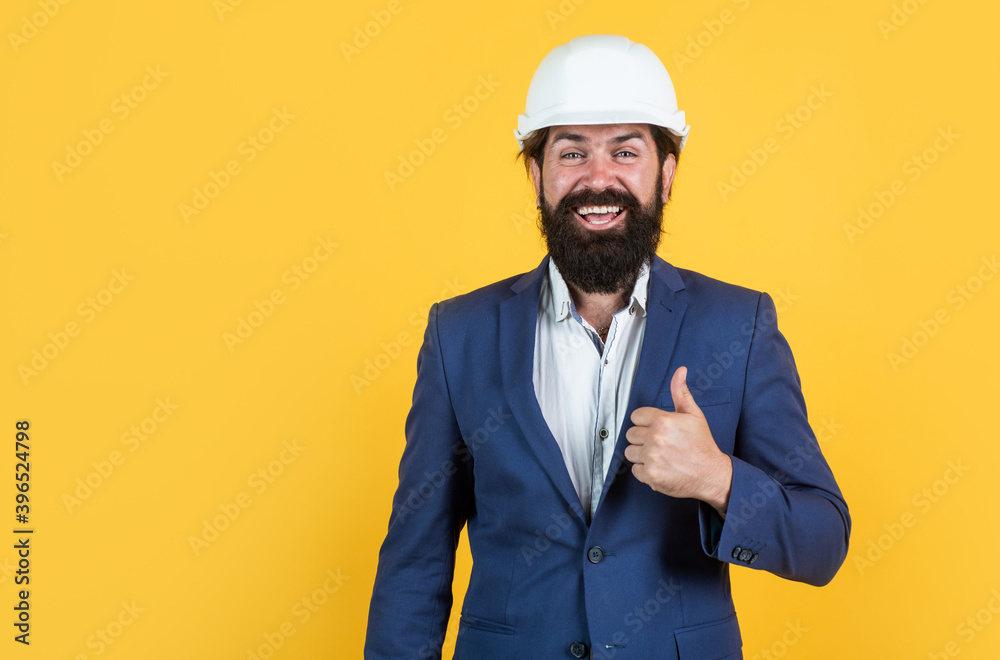 happy mature architect in helmet. brutal bearded man work on construction site. working on project. building concept. builder or engineer in hard hat. showing thumb up. best and success. copy space happy mature architect in helmet. brutal bearded man work on construction site. working on project. building concept. builder or engineer in hard hat. showing thumb up. best and success. copy space