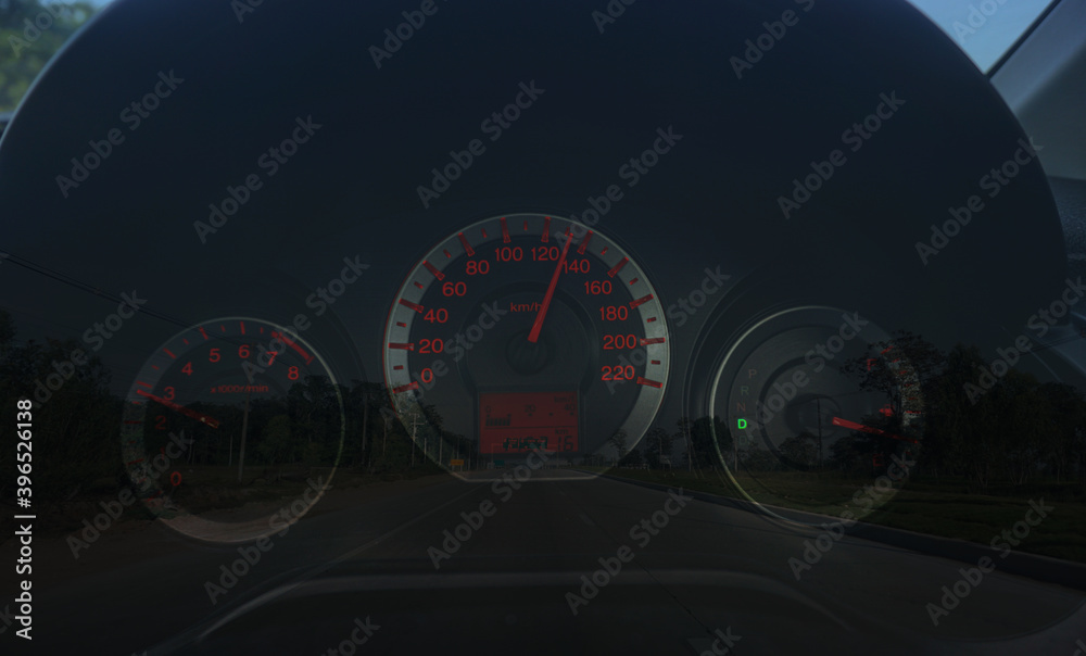 Speedometer 110 kilometre over a blurred road representing driving very fast Evening background.