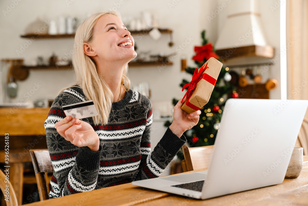 Happy smiling woman holding credit card Happy smiling woman holding credit card