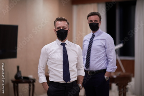 business team wearing crona virus protection face mask photo