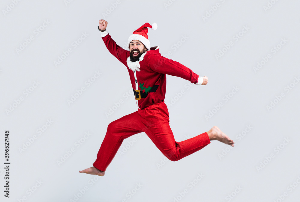 Full body photo of amazed jumping man excited by x-mas prices hurry shopping wear santa claus costume, happy new year
