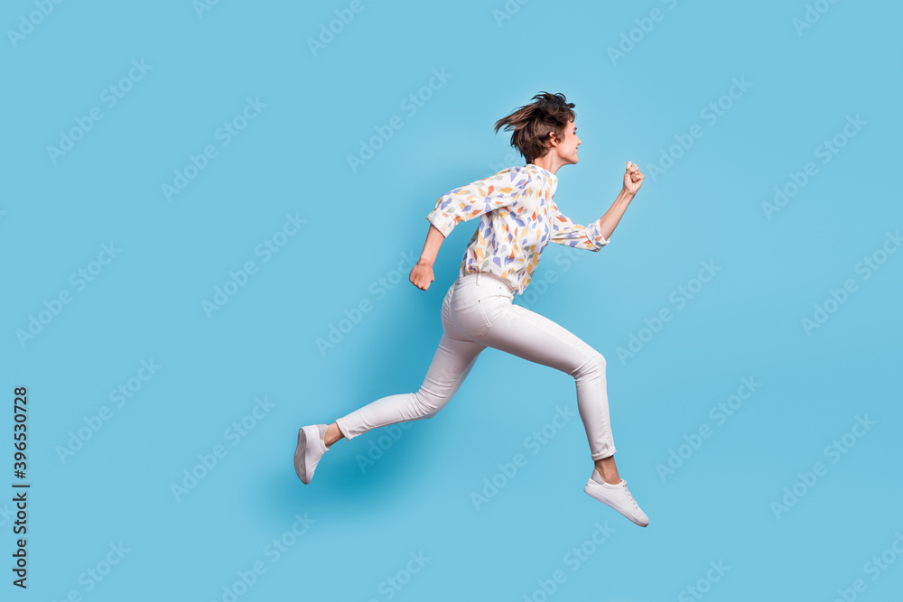 Full body profile side photo of young active girl happy hurry run jump sale look empty space isolated over blue color background