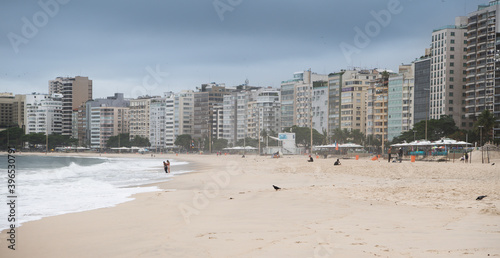  Citizens swim and sunbathe on the beach of Copacabana © aleks