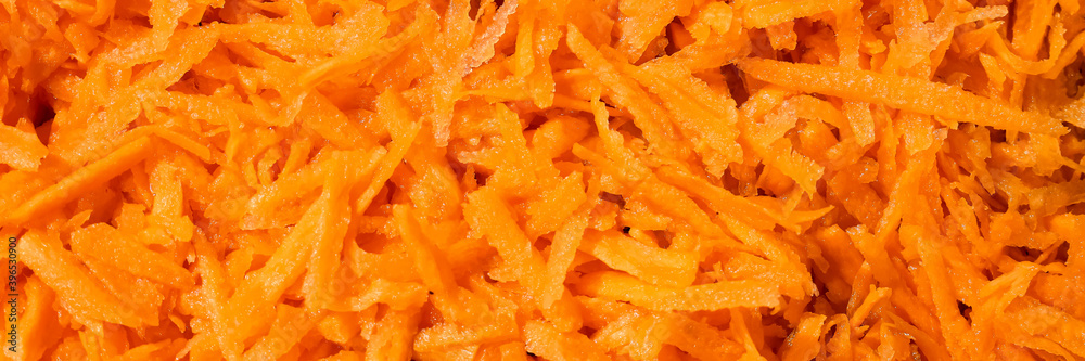 Fresh Carrots sliced close up, pattern. Texture of grated carrot. Orange food background. Web banner. Fresh Carrots sliced close up, pattern. Texture of grated carrot. Orange food background. Web banner.