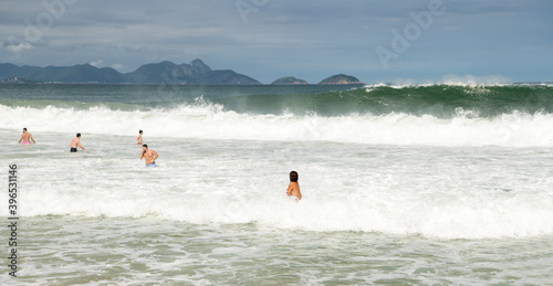   Citizens swim  on the beach of Copacabana © aleks