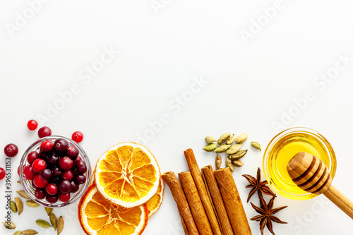 Various spices for preparing mulled wine hot drink. Cinnamon, honey, spices and cranberries