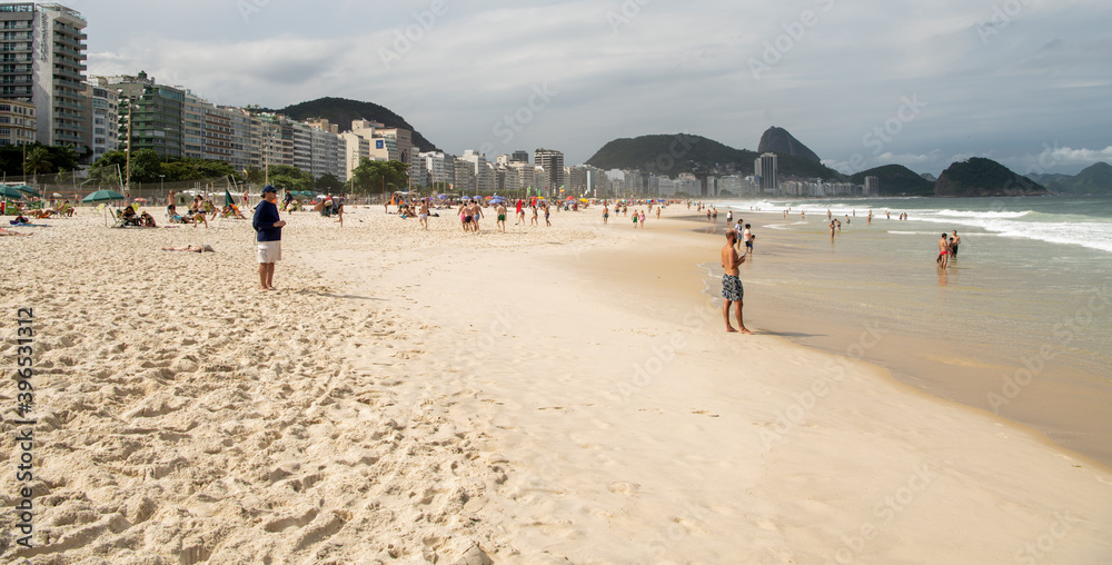 Citizens swim and sunbathe on the beach of Copacabana Citizens swim and sunbathe on the beach of Copacabana