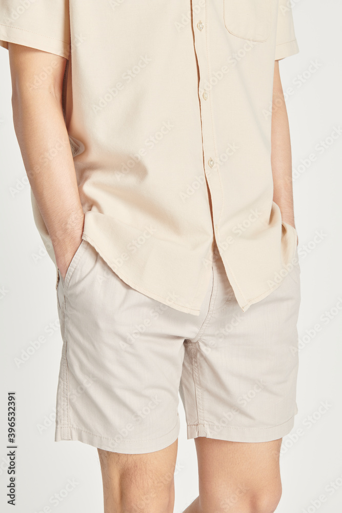 Man wearing a minimal beige shirt mockup Man wearing a minimal beige shirt mockup
