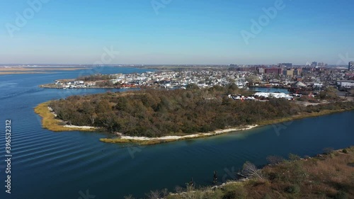 Wallpaper Mural An aerial shot over Grassy Bay in Queens, NY. The camera dolly in & pan left towards an uninhabited peninsula. The sun shining & it is a beautiful day. Torontodigital.ca