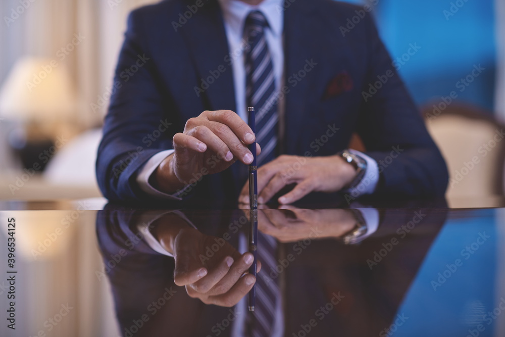 corporate businessman at luxury office pen holding 