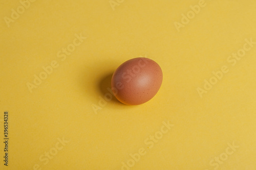 An egg on a yellow background