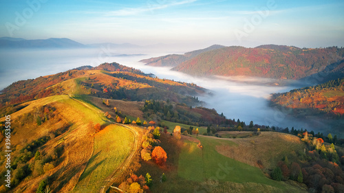 Obraz na płótnie Beautiful Autumn mountain panorama. Morning thick fog cover valley aerial view. Fantastic fall sunrise w salonie