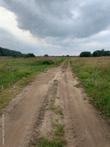 Hiking track in the field, countryside road