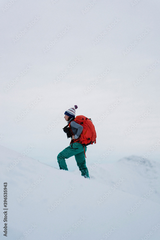 Woman hiking on a snowy mountain