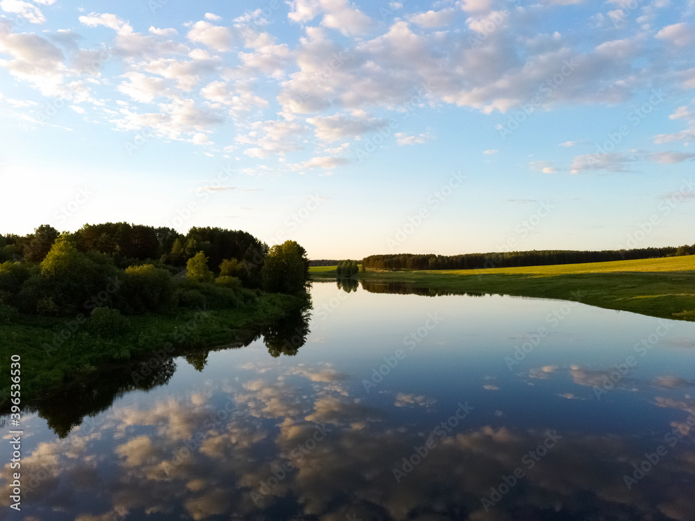 river with reflection of clouds on a summer day at sunset.view from a drone. river with reflection of clouds on a summer day at sunset.view from a drone.