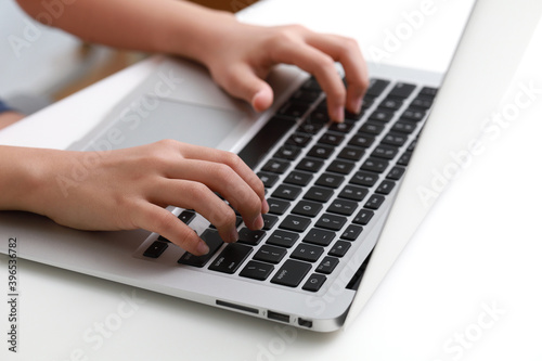 Cropped hand of a teenager using laptop computer
