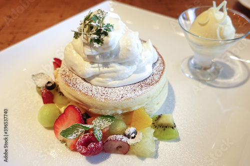 Delicious flufy fruits pancakes with ice cream. Japanese famous dessert. photo