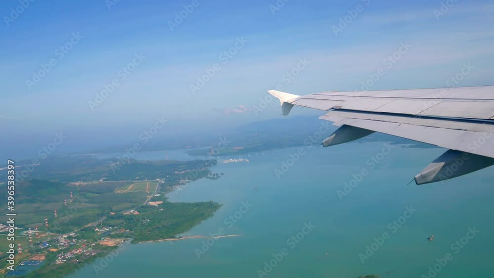 Travel Video View from the airplane window over the wings and engines The aircraft are take off or flying through island and Good weather transportation concept 4K Resolution wide angle shot. Travel Video View from the airplane window over the wings and engines The aircraft are take off or flying through island and Good weather transportation concept 4K Resolution wide angle shot.