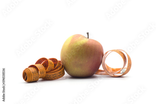 Closeup of mesureing tape on apple on white background - dieting concept photo