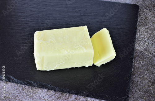 Block of butter, on slate board