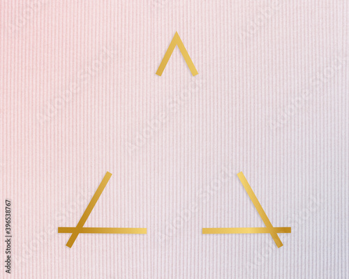 Gold ftriangle rame on a pinkish blue fabric background photo