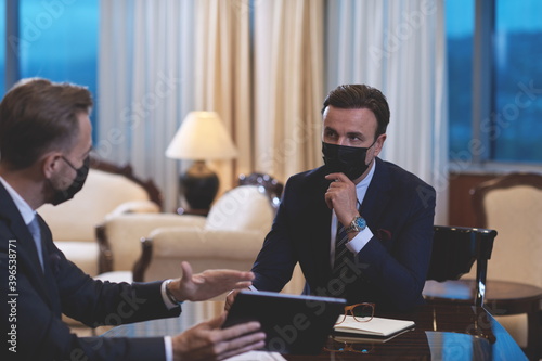 business people wearing crona virus protection face mask on meeting photo