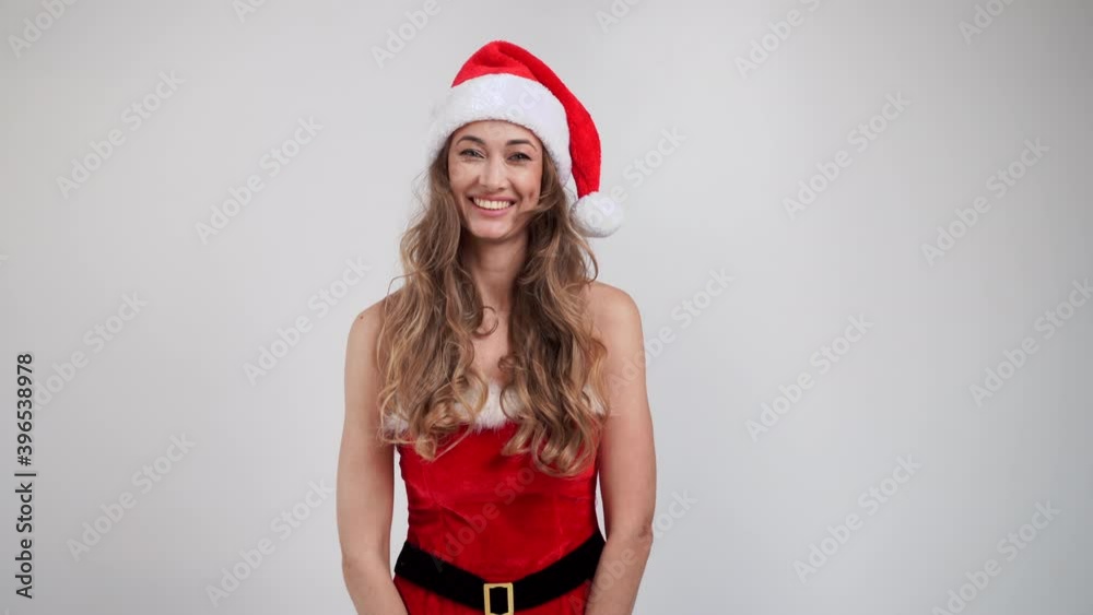 Woman Christmas Santa Hat white studio background Beautiful caucasian female curly hair portrait Happy person positive emotion Holiday concept Blowing a kiss Woman Christmas Santa Hat white studio background Beautiful caucasian female curly hair portrait Happy person positive emotion Holiday concept Blowing a kiss
