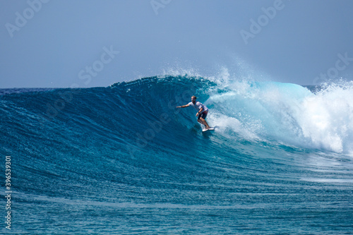 Surfer on perfect blue aquamarine wave, empty line up, perfect for surfing, clean water, Indian Ocean .