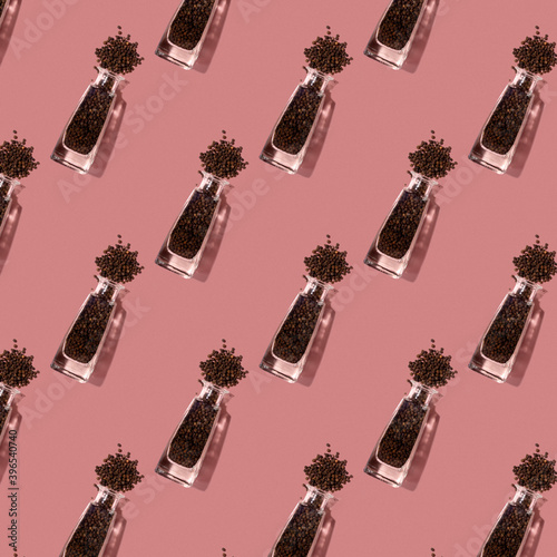Seamless pattern with black pepper in crystal clear bottles.