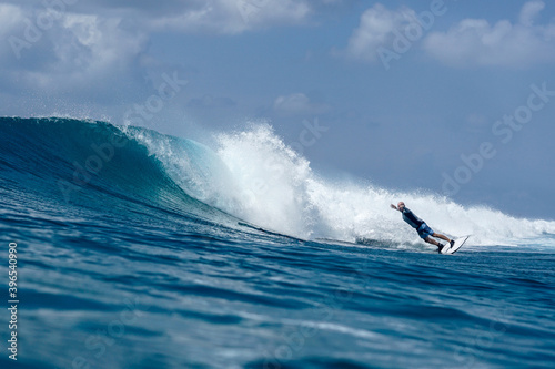 Surfer on perfect blue aquamarine wave, empty line up, perfect for surfing, clean water, Indian Ocean