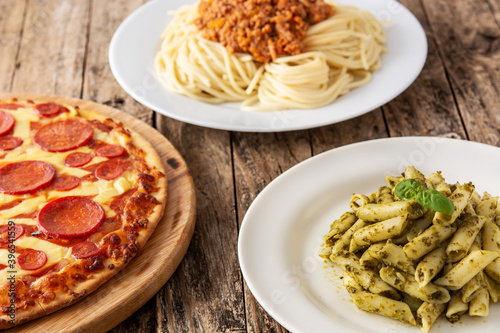 Assortment of Italian pasta dishes on wooden table