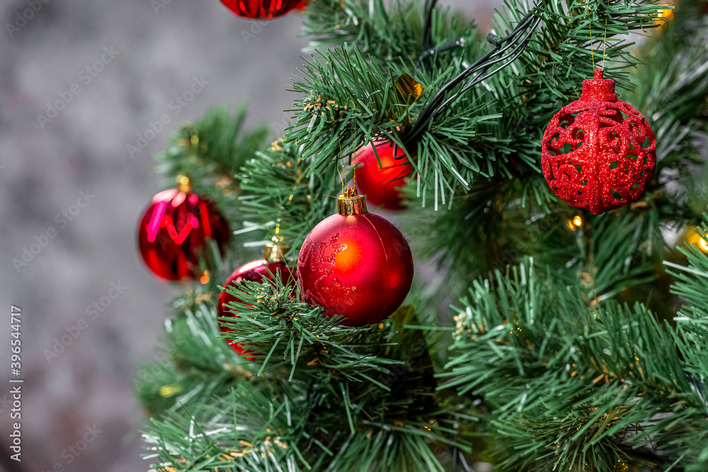 Christmas tree with garlands and red balls in the living room, beautiful new year background