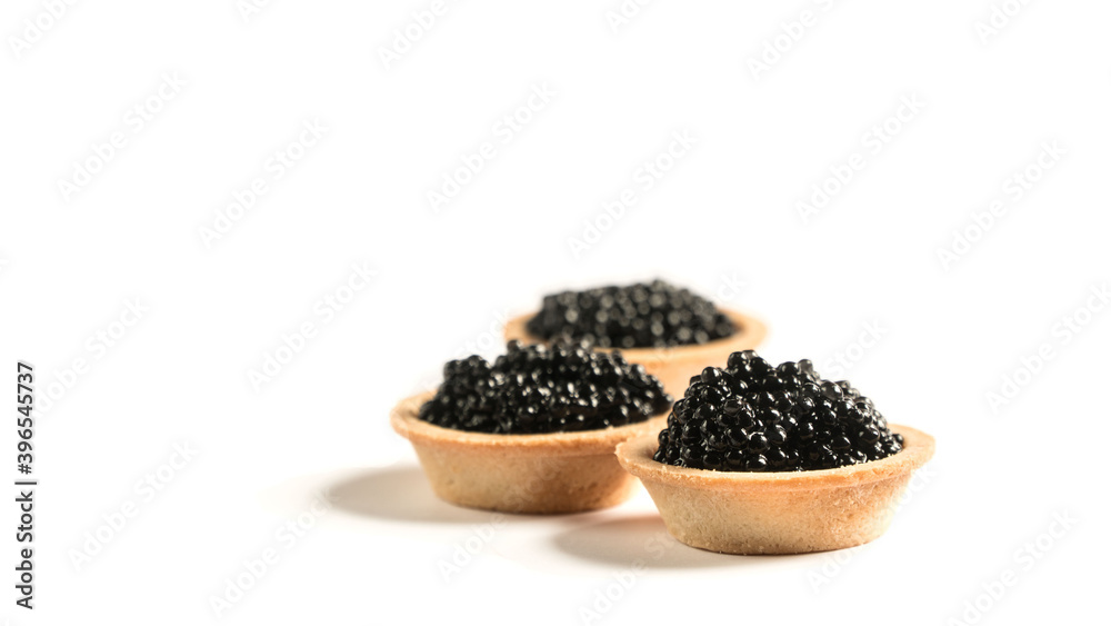 black caviar on a white plate. tartlet with black caviar. snack.
black caviar on a white plate. tartlet with black caviar. snack.