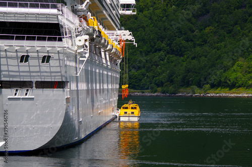 Huge Costa cruiseship or cruise ship liner Favolosa in Norwegian Geirangerfjord in Norway with peaceful landscape and breathtaking picturesque landscape scenery with mountains and snow in summer photo